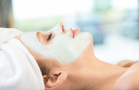 Woman relaxing while getting a facial