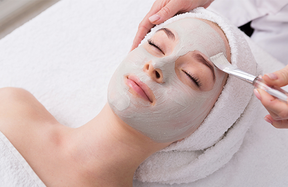 Woman relaxing while getting a facial