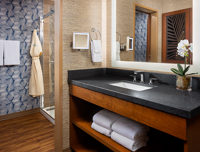  Bathroom dressing area with robes in the Bayfront Suite at the Catamaran Resort Hotel and Spa in San Diego beaches.