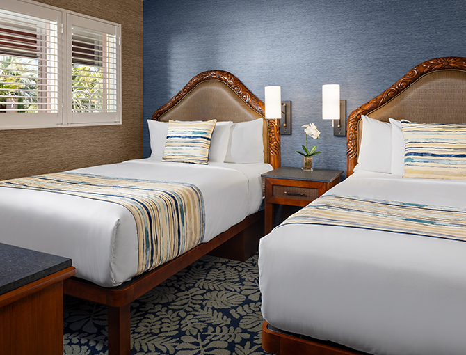 Separate bedroom with two double beds in the Catamaran Resort Hotel’s Bayfront Suite in San Diego.