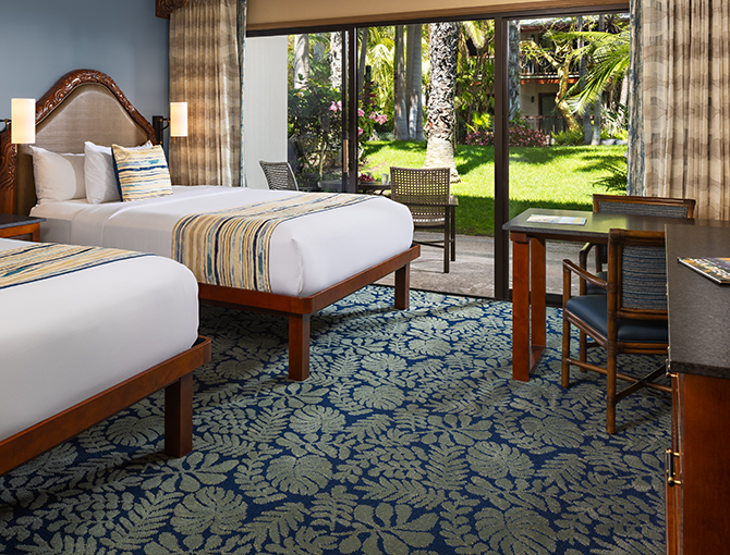 Resort Room with two queen beds and game table with private patio to the gardens at the Catamaran Resort hotel in San Diego beaches.