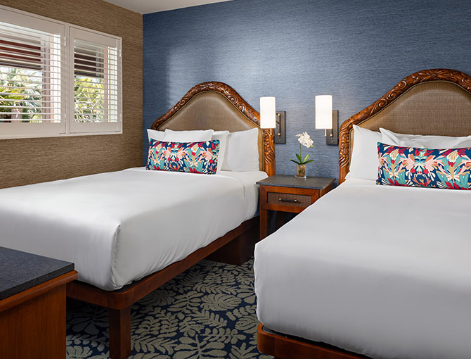 Separate bedroom with two double beds in the Catamaran Resort Hotel’s Bayfront Suite in San Diego.