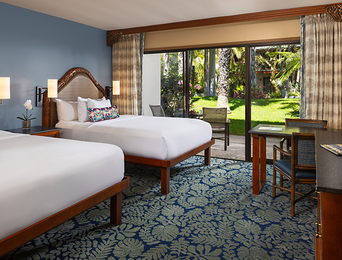 Resort Room with two queen beds and game table with private patio to the gardens at the Catamaran Resort hotel in San Diego beaches.